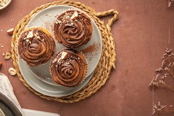 Chocolate chip muffins decorated with chocolate ganache and hazelnut