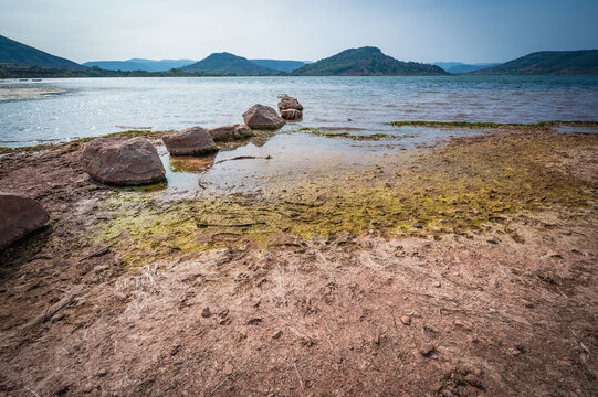 Landscape of red rocks and Green algae in summer of Lake Salagou , Occitanie, France, High quality photo