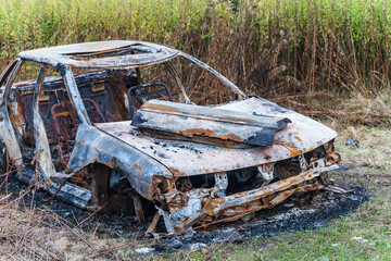 A burnt-out car. Fire burned car. Car old burned by fire.