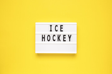 The word ice hockey on lightbox isolated yellow background. Type of winter sports game.