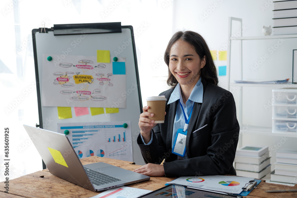Aufkleber asian businesswoman using laptop computer and working at office with calculator document on desk