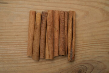 Cinnamon sticks on wood background 