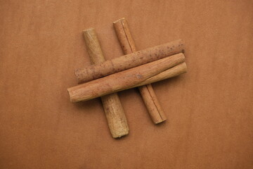 Cinnamon sticks on brown background , top angle view