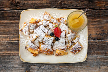 Delicious kaiserschmarrn on wooden table with tablecloth