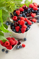 Colorful assorted mix of blueberries, raspberries, and sweet cherries.