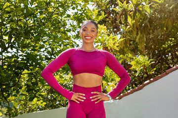 Fit young black woman exercising outdoor at garden