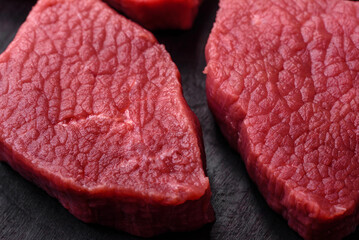 Juicy fresh raw beef meat with salt, spices and herbs