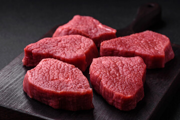 Juicy fresh raw beef meat with salt, spices and herbs