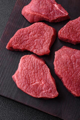 Juicy fresh raw beef meat with salt, spices and herbs