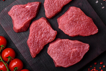 Juicy fresh raw beef meat with salt, spices and herbs