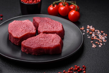 Juicy fresh raw beef meat with salt, spices and herbs