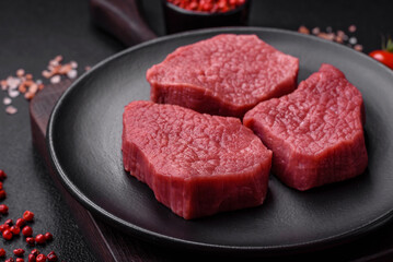 Juicy fresh raw beef meat with salt, spices and herbs