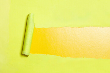 Torn paper with opening showing yellow background.