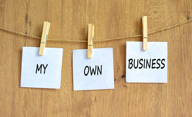 My own business symbol. Concept words My own business on beautiful white paper on clothespin. Beautiful wooden background. Business motivational my own business concept. Copy space.