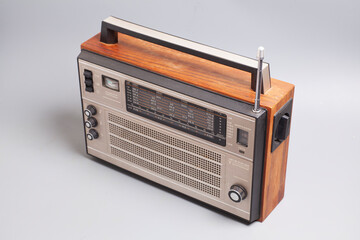 Vintage transistor radio isolated on white. English translation: indicator settings,landmark scale,...