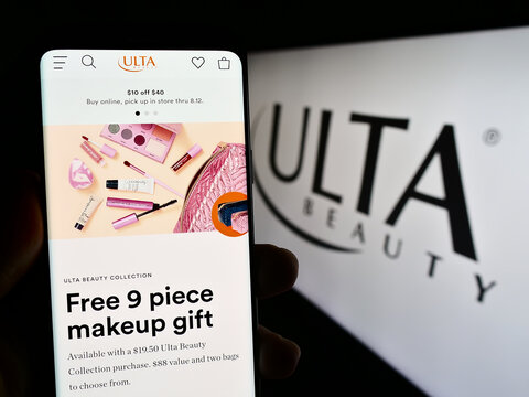 Stuttgart, Germany - 08-11-2023: Person holding cellphone with web page of US cosmetics retail company Ulta Beauty Inc. on screen with logo. Focus on center of phone display.