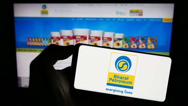 Stuttgart, Germany - 08-13-2023: Person holding smartphone with logo of Bharat Petroleum Corporation Limited (BPCL) on screen in front of website. Focus on phone display.