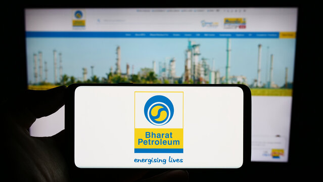 Stuttgart, Germany - 08-13-2023: Person holding cellphone with logo of Bharat Petroleum Corporation Limited (BPCL) on screen in front of business webpage. Focus on phone display.