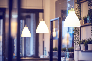A row of lamps in the interior of the restaurant. Modern lighting fixtures as restaurant interior...