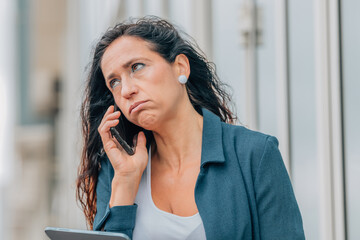 stressed business woman talking on mobile phone