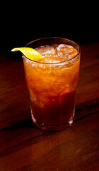 cocktail with jagermeister in thumbler glass with orange and ice isolated on black background m angle