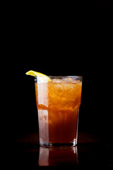 cocktail with jagermeister in thumbler glass with orange and ice isolated on black background