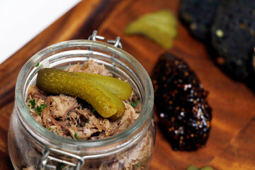 confit pulled duck spread or rillette with fig jam and breads in close up