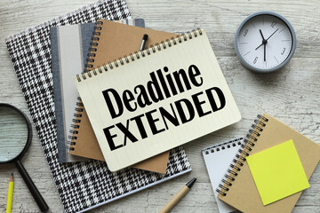 DEADLINE EXTENDED. work desk table clock. text on the page
