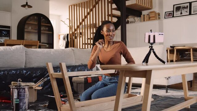 A Black Woman Filming a DIY Project in Her living Room