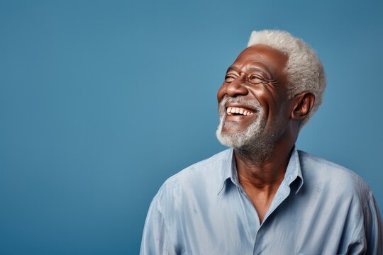 Portrait of a Mature Black Man Looking Left on a Blue Background