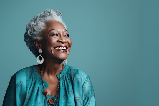 Portrait of a Mature Black Woman Looking Right on a Teal Background