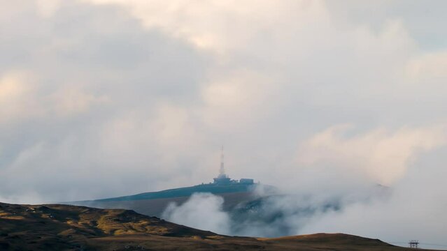 Time lapse of clouds moving past a radio relay located at 2498m altitude in Bucegi mountains, Romania. Time lapse of Costila radio relay located on mountain peak
