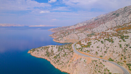 AERIAL Picturesque landscape in warm autumn shades with winding Adriatic highway - obrazy, fototapety, plakaty