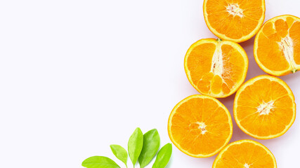 Orange fruit with green leaves on white background.