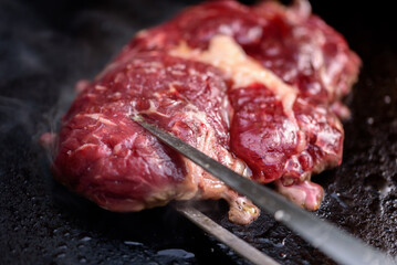 Rib-eye steaks on a gas grill. Chef cooking steak on a grill.