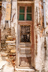 Rustic decay in traditional European village showing old stones, worn wood, awaiting restoration in the beautiful village Greek Island - Tinos Island.