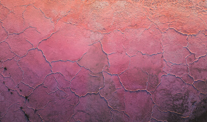 A close-up of a cracked pink salt lake at sunset creating abstract patterns. Salt production plants evaporated a brine pond in a salt lake. Salin de Giraud saltworks in Camargue, Provence, France