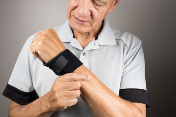 Man wearing a wrist brace or wrap on his left hand and wrist for pain management