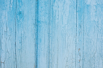 Fototapeta na wymiar light blue cracked sun-bleached wooden background.