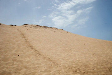 Dunes of Melides Lagoon under serene skies, a tranquil coastal landscape. Nature's beauty captured in this breathtaking stock photo.