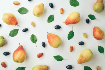 Light autumn background. Ripe yellow fragrant pears and grapes. Thanksgiving background. Fruits on a light background.