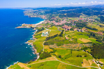 Scenic view from drone of coastal Spanish township of Comillas on sunny summer day, Cantabria