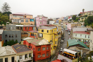 Charming houses painted in vivid colors adorn the picturesque hills of Valparaíso, forming a vibrant and captivating urban landscape.