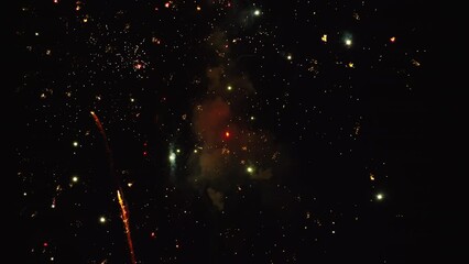 Flurry of fireworks explode in slow motion at nighttime fireworks show