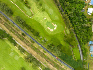 Aerial view drone shot of beautiful green golf field fairway and putting green,Top down image for sport background and travel background