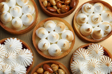 Many different tartlets on golden tray, top view. Delicious dessert