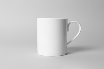 White ceramic mug on light grey background