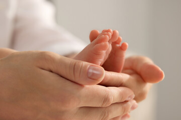 Mother holding her newborn baby, closeup view