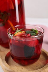 Glass of delicious refreshing sangria on tray, closeup