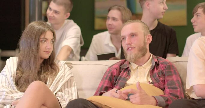 Practicing Greatnes Participants learn to notice and appreciate positive things in their lives. A group of people discussing positive points lecture. Bearded man center frame.